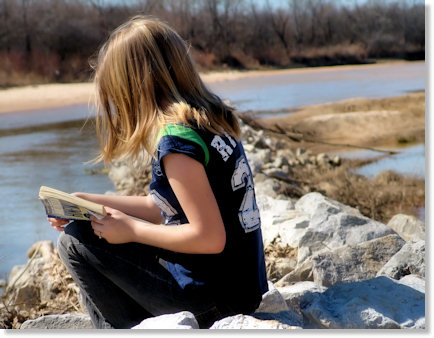 Haley reading at the river.